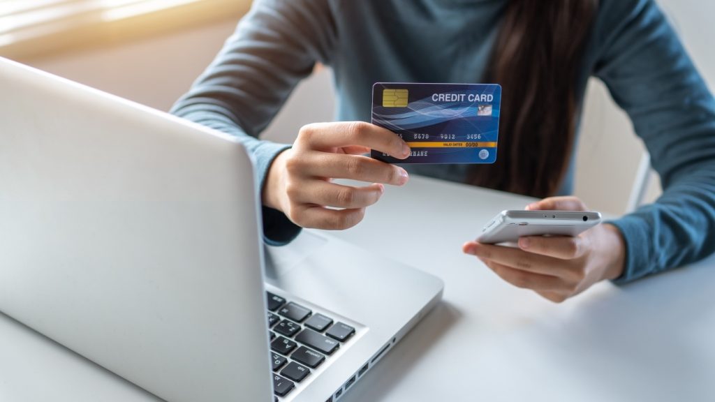 Woman making online payment with credit card and smartphone