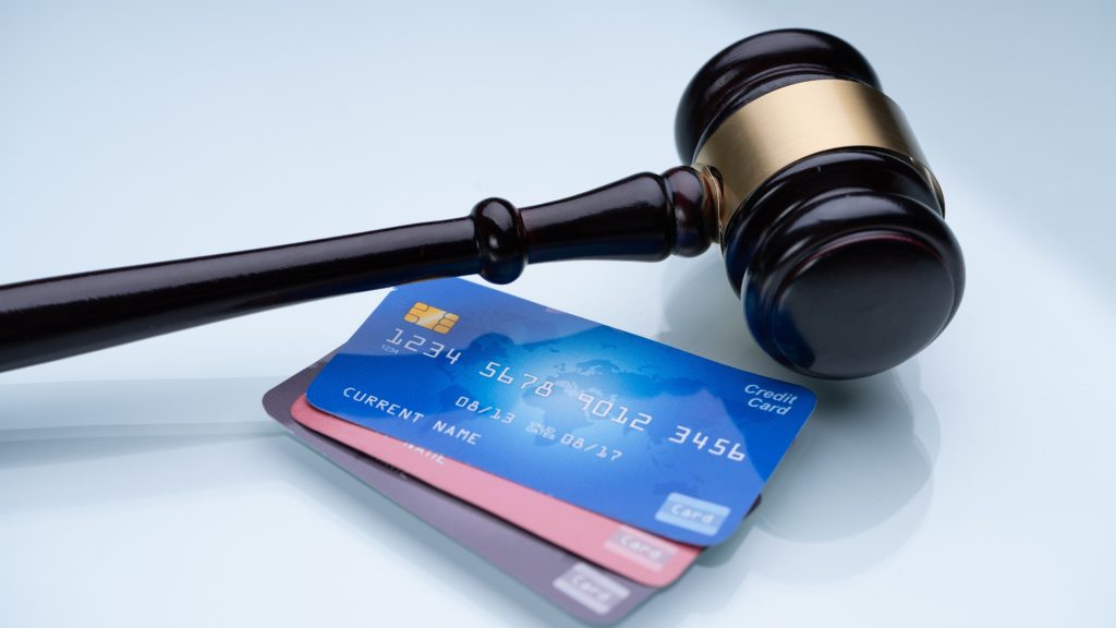 Judge's gavel next to credit cards – symbolizing credit law, debt judgment, or financial legal issues.