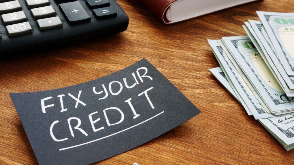 Fix Your Credit note beside cash, calculator, and notebook on a wooden desk