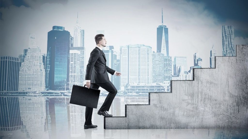 Businessman climbing concrete stairs with a city skyline backdrop, symbolizing career growth and financial success.Bad credit repair help.